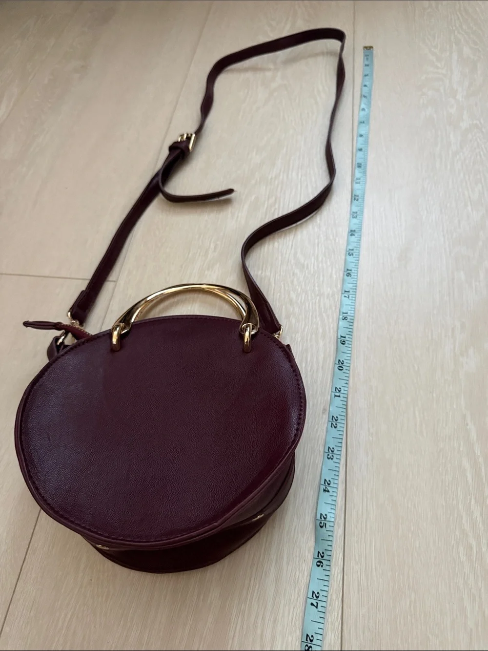 Round Crossbody Bag in Plum with Gold Accents